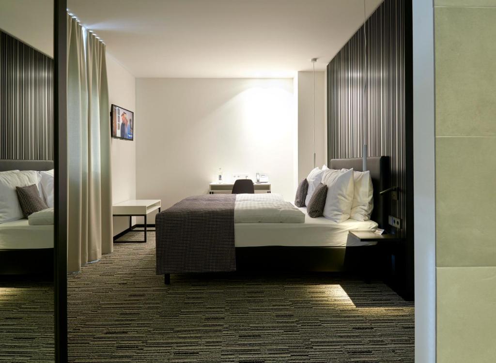 a hotel room with a bed and a desk at Hostellerie Stafelter in Walferdange