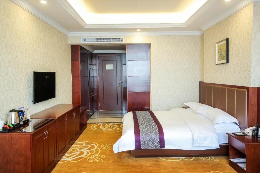 Postel nebo postele na pokoji v ubytování Xin Jue Jiayi Hotel Airport and International Resort