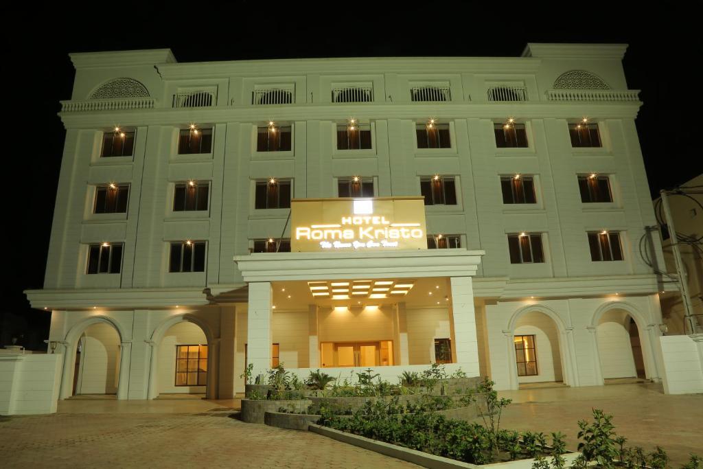 a large white building with a sign on it at Hotel Roma Kristo in Dwarka