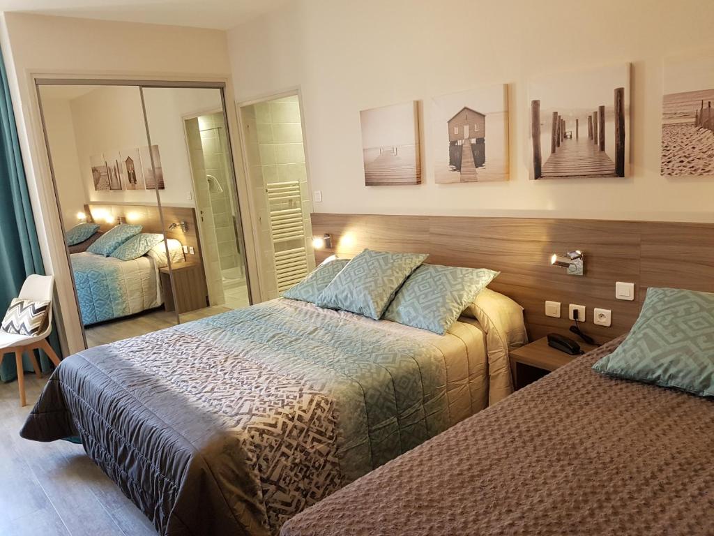 Un ou plusieurs lits dans un hébergement de l'établissement Hotel du Midi - Rodez Centre Ville