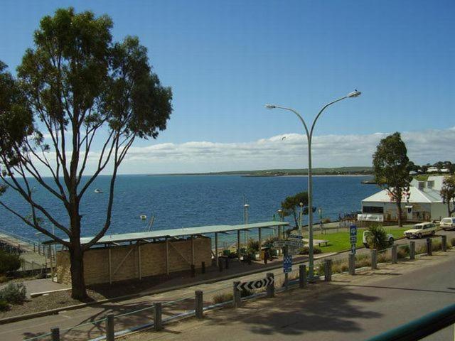 a street with a building next to a body of water at Streaky Bay Hotel Motel in Streaky Bay