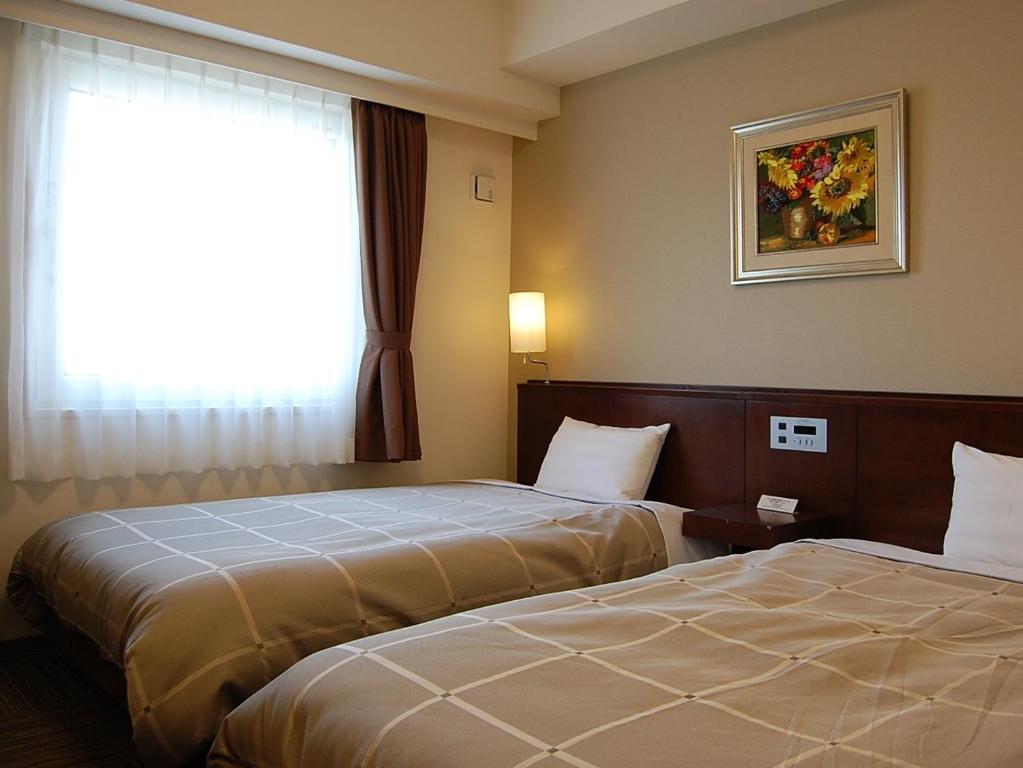 Postel nebo postele na pokoji v ubytování Hotel Route-Inn Nabari