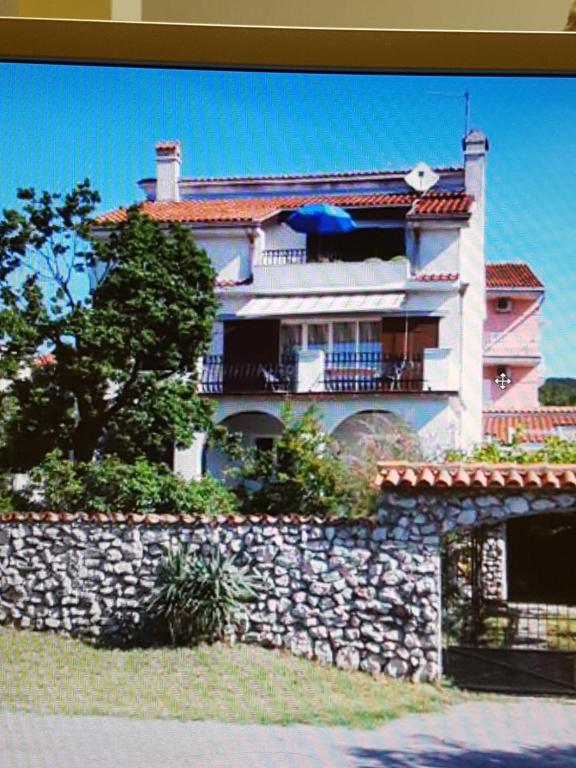 a large house on top of a stone wall at Rea in Crikvenica