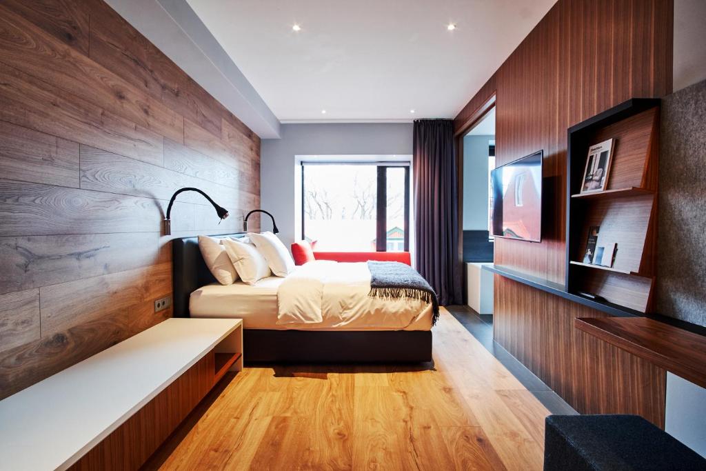 a bedroom with a bed and a tv on a wall at ION City Hotel in Reykjavík