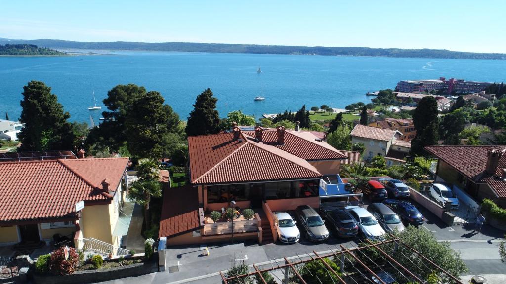 arial view of a house with cars parked in a parking lot at Pension Silvia in Portorož