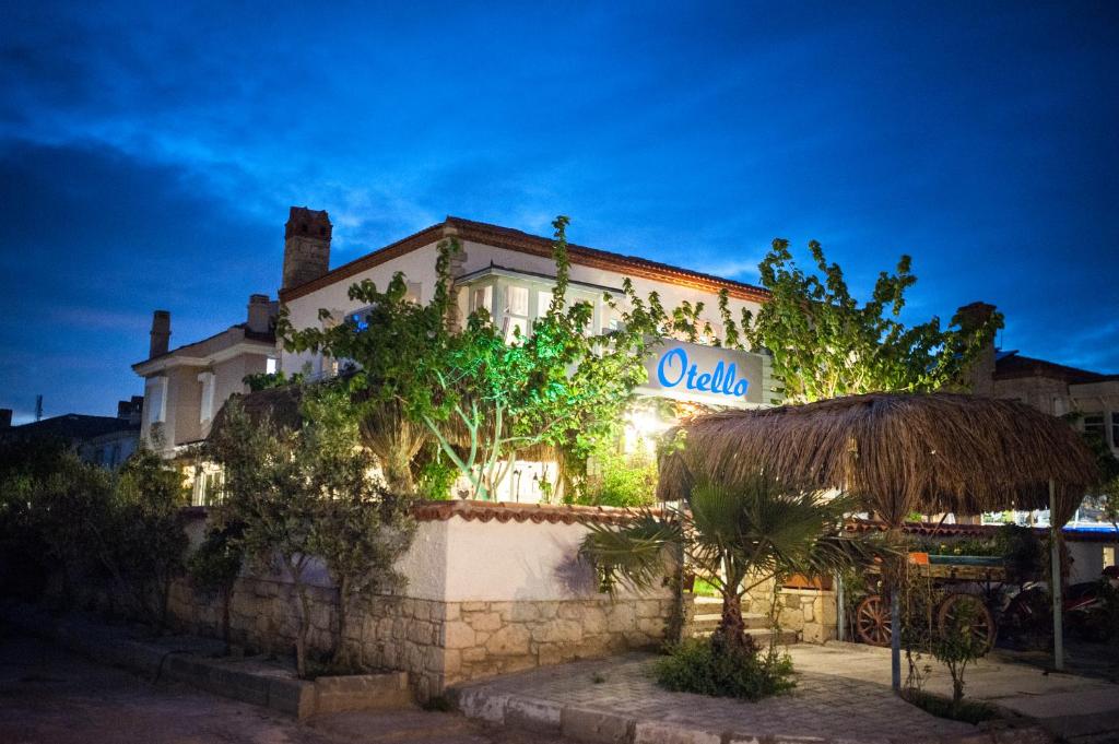 a hotel with a sign on the side of a building at Otello Alacati in Alacati