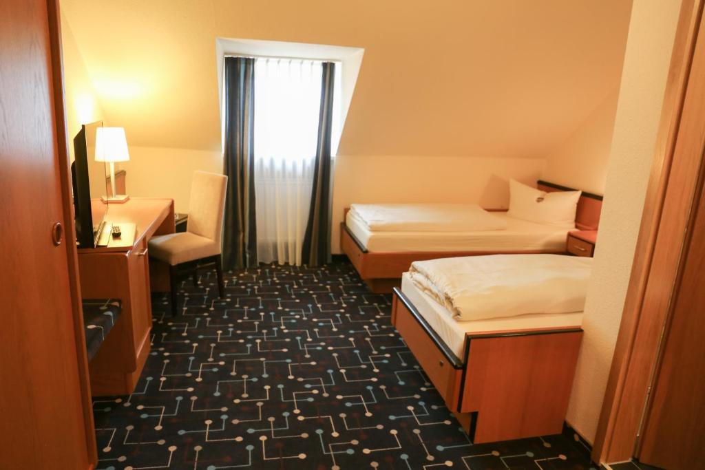 Postel nebo postele na pokoji v ubytování Hotel Königer