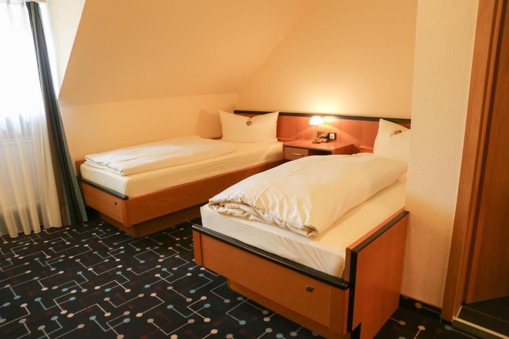 Postel nebo postele na pokoji v ubytování Hotel Königer