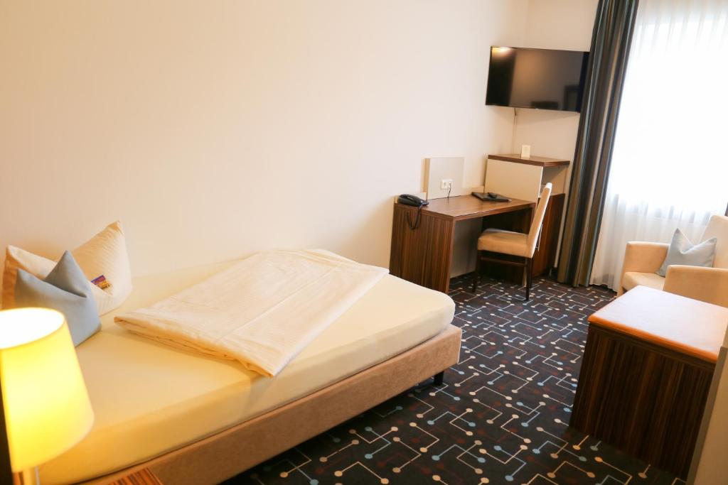 Postel nebo postele na pokoji v ubytování Hotel Königer