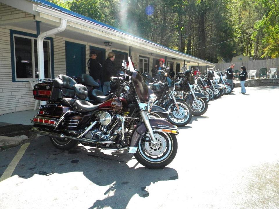 a row of motorcycles parked outside of a building at Clarketon Motel - Maggie Valley in Maggie Valley