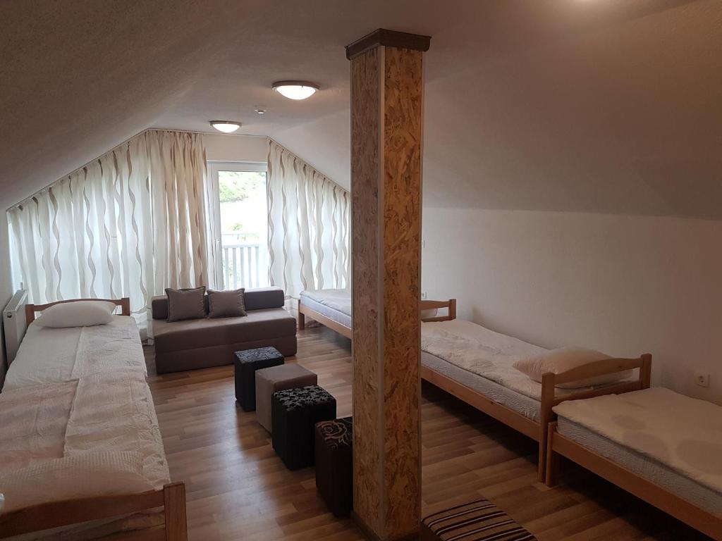 a living room with two beds and a couch at Apartments Pyramid of the Sun in Visoko