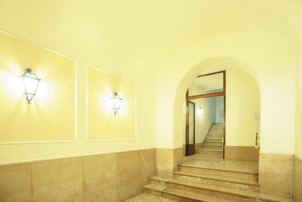 a hallway with stairs and lights on the wall at Gialel B&B in Rome