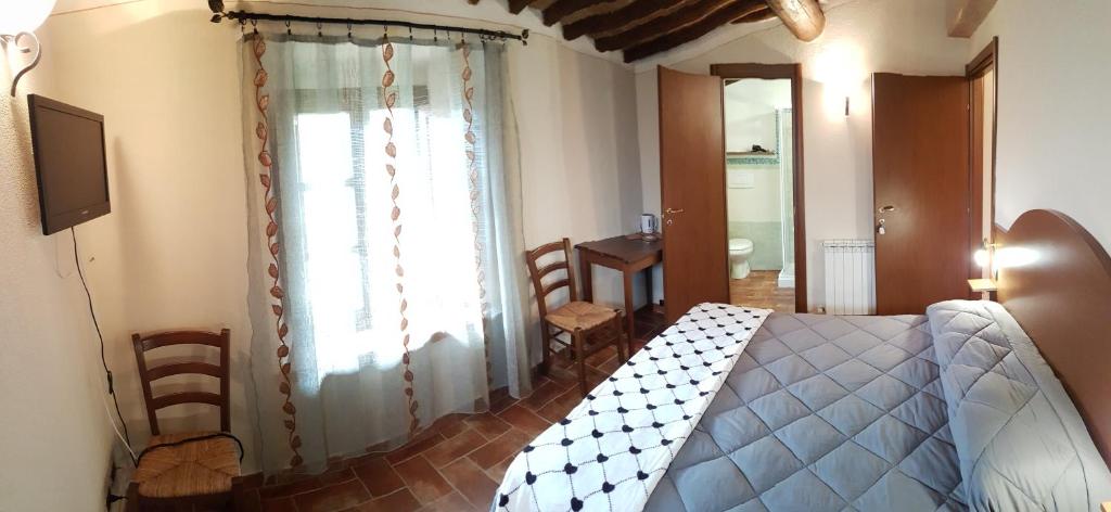 A bed or beds in a room at Il Pozzo Di Sant'Andrea