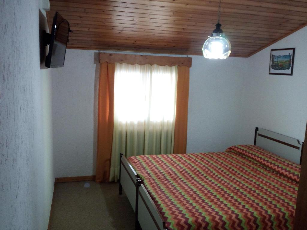 Postel nebo postele na pokoji v ubytování Albergo Al Pino