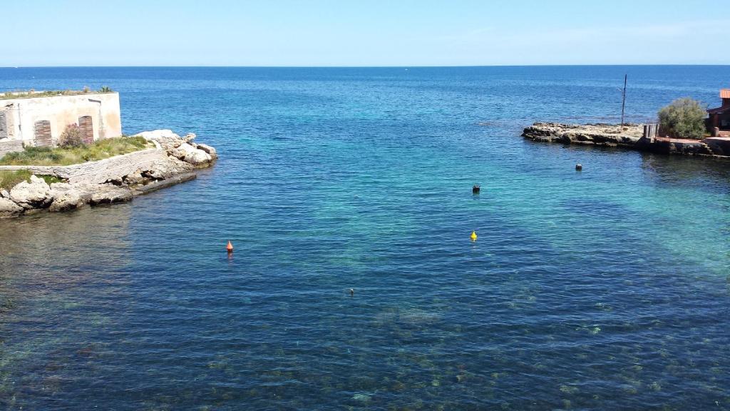 a large body of water with people swimming in it at Casa Mimi in Santa Flavia