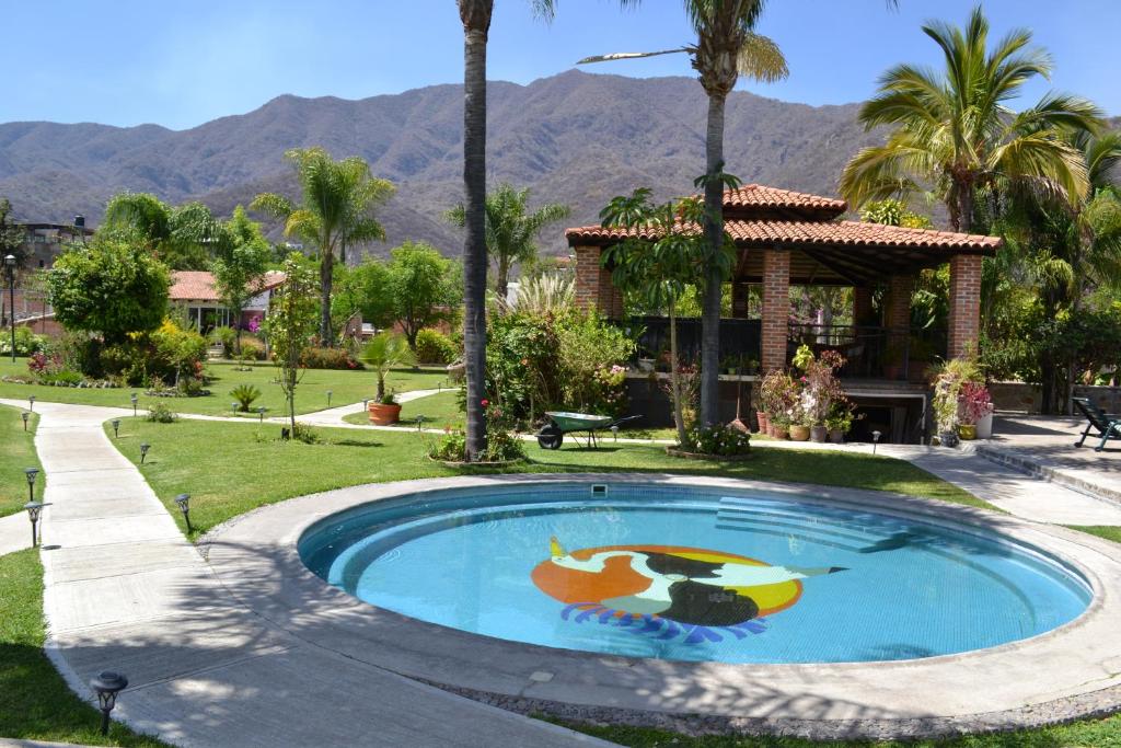 a pool with a painting on it in front of a house at La Joya del Lago in Ajijic