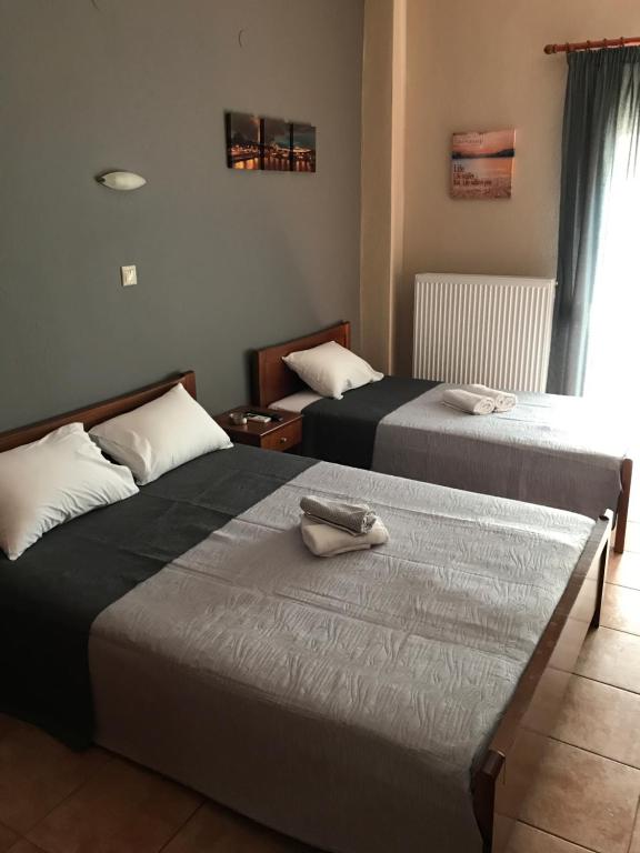 two beds sitting next to each other in a room at Villa Un bel posto Sea View in Nea Vrasna