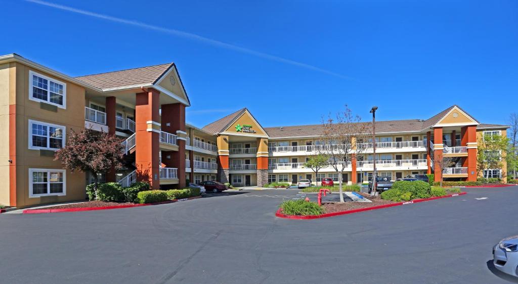 an empty parking lot in front of a hotel at Extended Stay America Suites - Sacramento - Arden Way in Sacramento