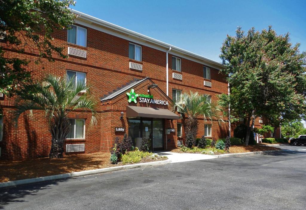 a red brick building with a star sign on it at Extended Stay America Suites - Charleston - Northwoods Blvd in Charleston