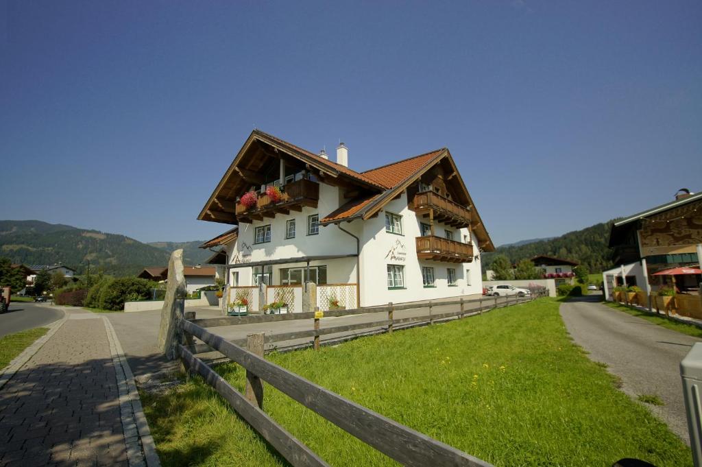 a white house on the side of a road at Appartement Alpenfex in Flachau