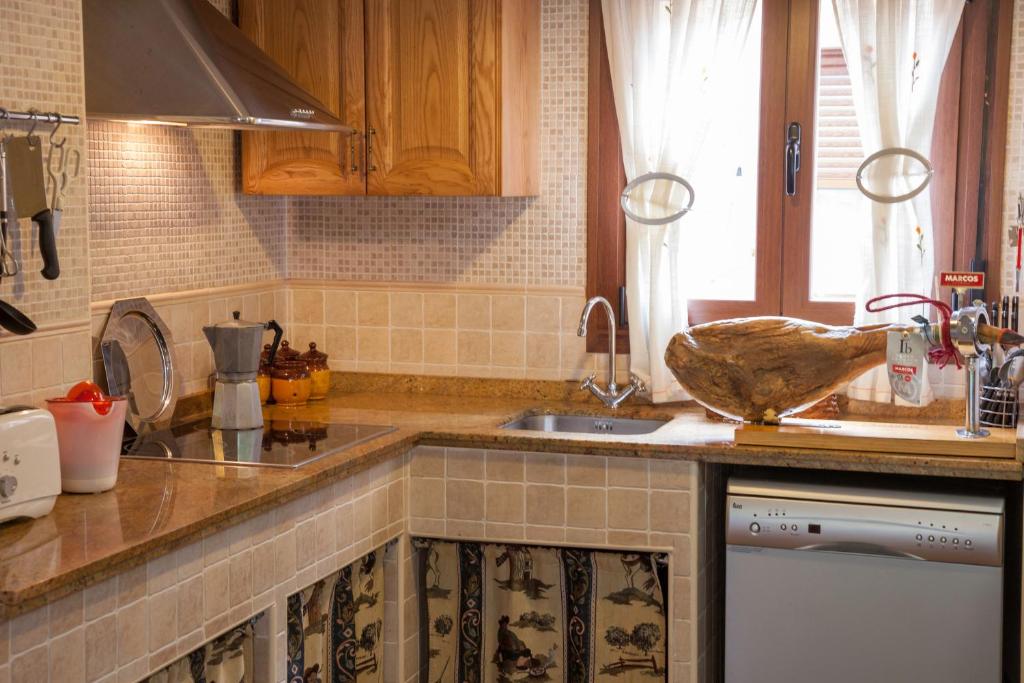 a kitchen with a sink and a counter top at Casas Rurales Arroal in Sotoserrano