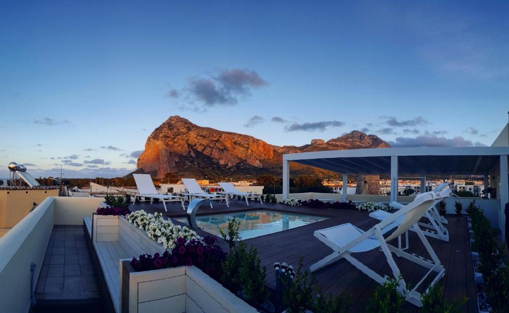 a view of a resort with a mountain in the background at Artemide Hotel in San Vito lo Capo