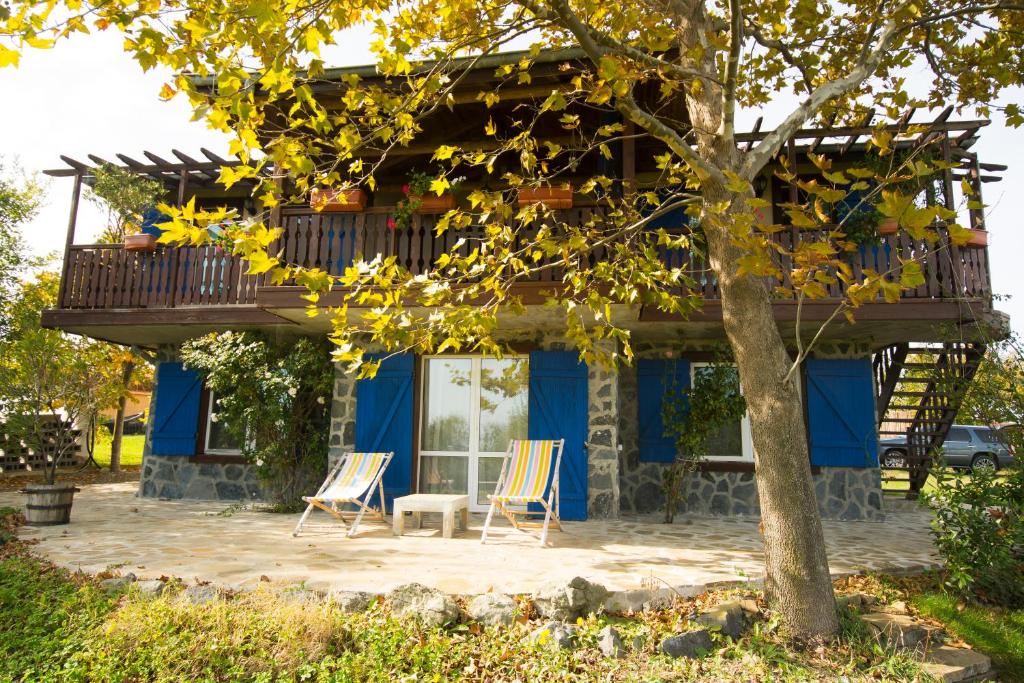 two chairs sitting in front of a house with a balcony at Art Provence House in Lozenets