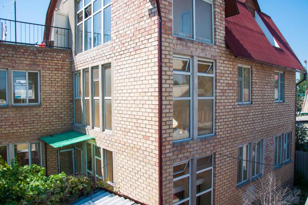 a brick building with windows on the side of it at Sakura Guesthouse in Bishkek
