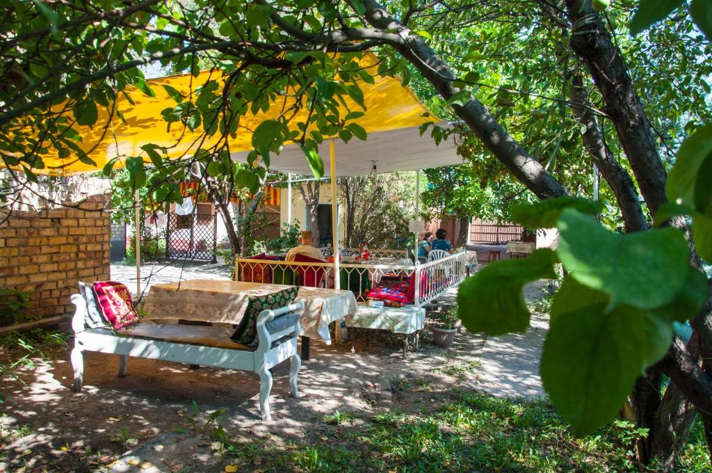 a group of tables and chairs under a tent at Sakura Guesthouse in Bishkek