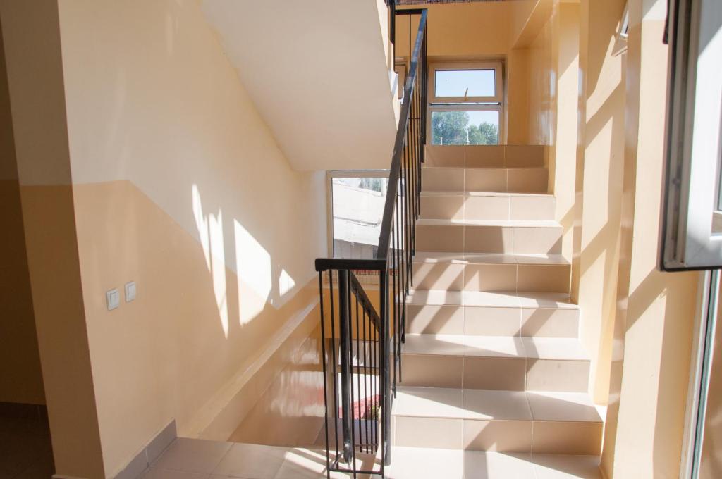 a staircase in a house with a window at Sakura Guesthouse in Bishkek