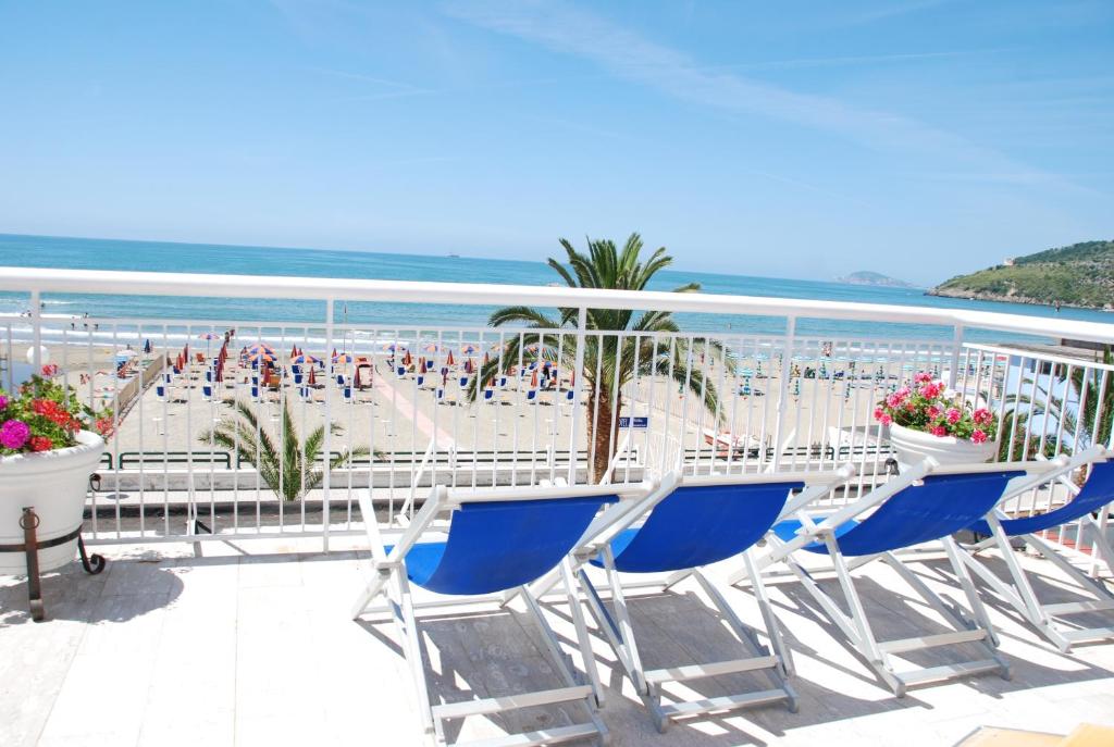 a balcony with chairs and a view of a beach at Hotel Villa Eleonora in Scauri