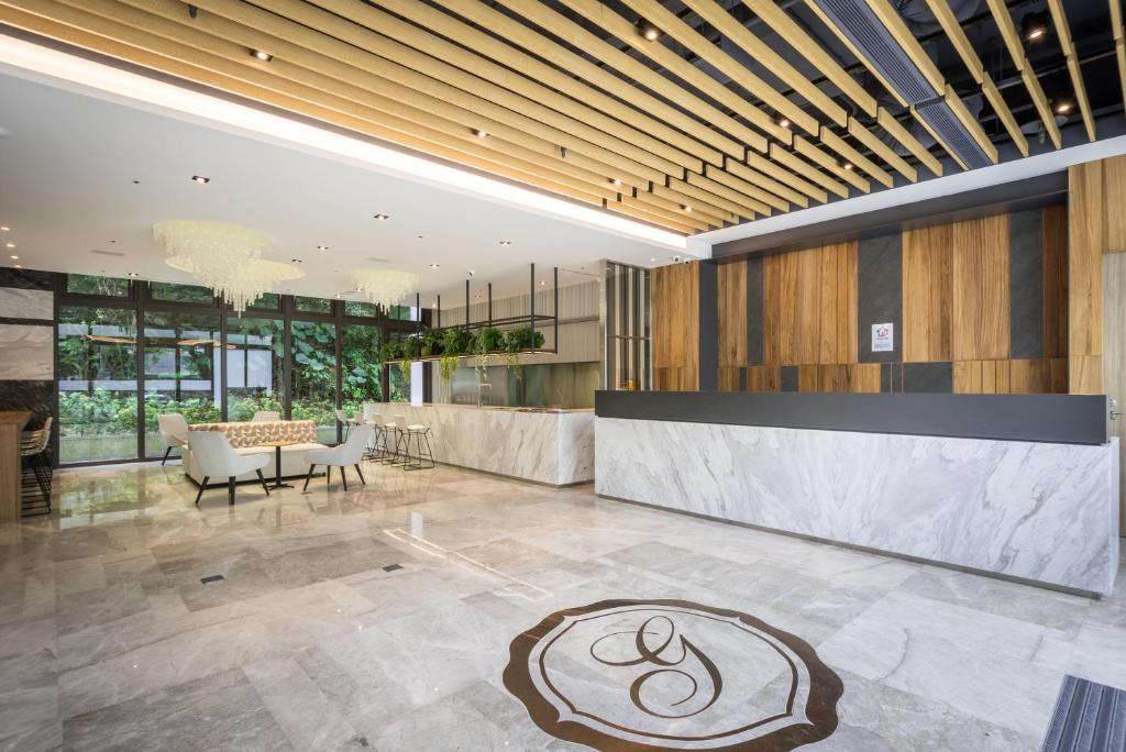 a lobby with a table and chairs in a building at Green World NanGang in Taipei