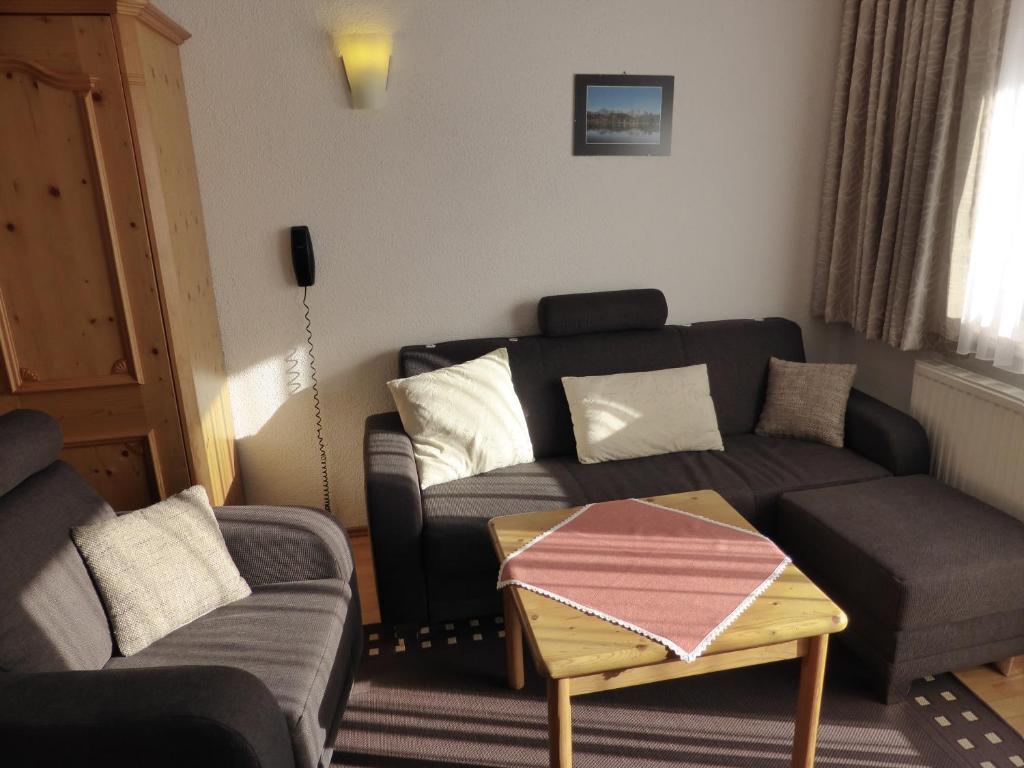 a living room with a couch and a coffee table at Haus Südblick Appartements in Seefeld in Tirol