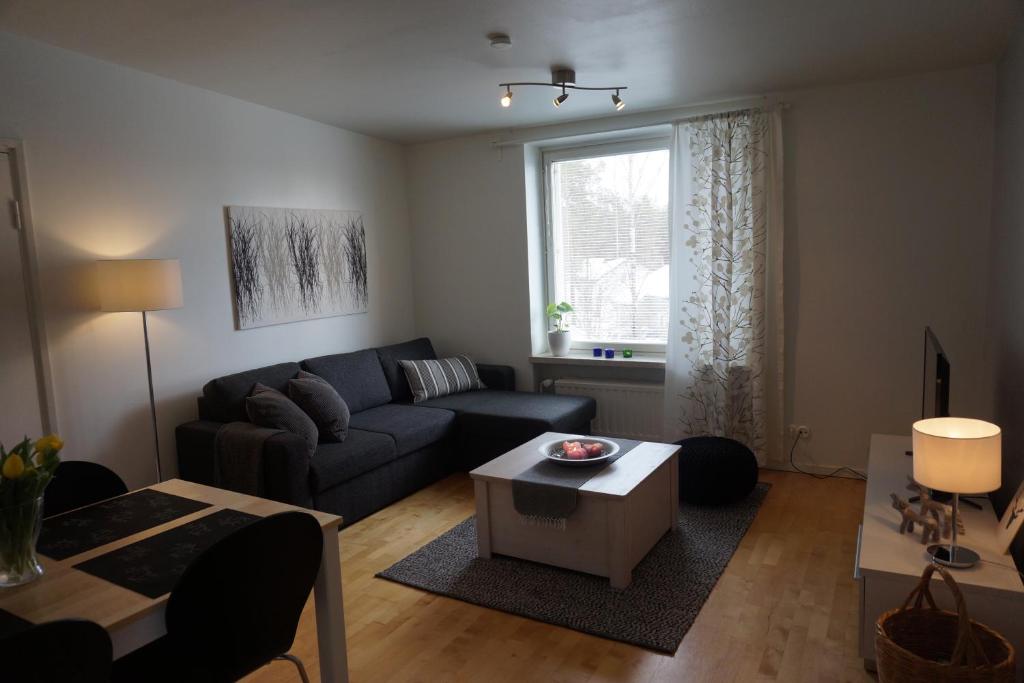 a living room with a couch and a table at Ounasvaara Arctic Suite in Rovaniemi