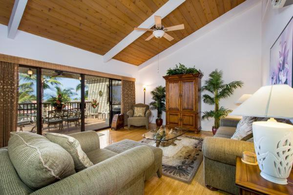 a living room with two couches and a ceiling fan at Kona Coast Resort at Keauhou Gardens 8204 in Kailua-Kona