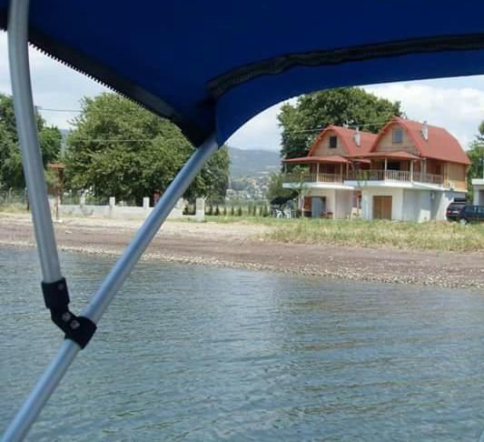 a house is seen from a boat in the water at Spilidis House in Karavómilos
