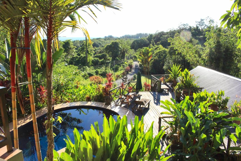 a view of a resort with a pool and trees at Nanga Damai Homestay in Santubong