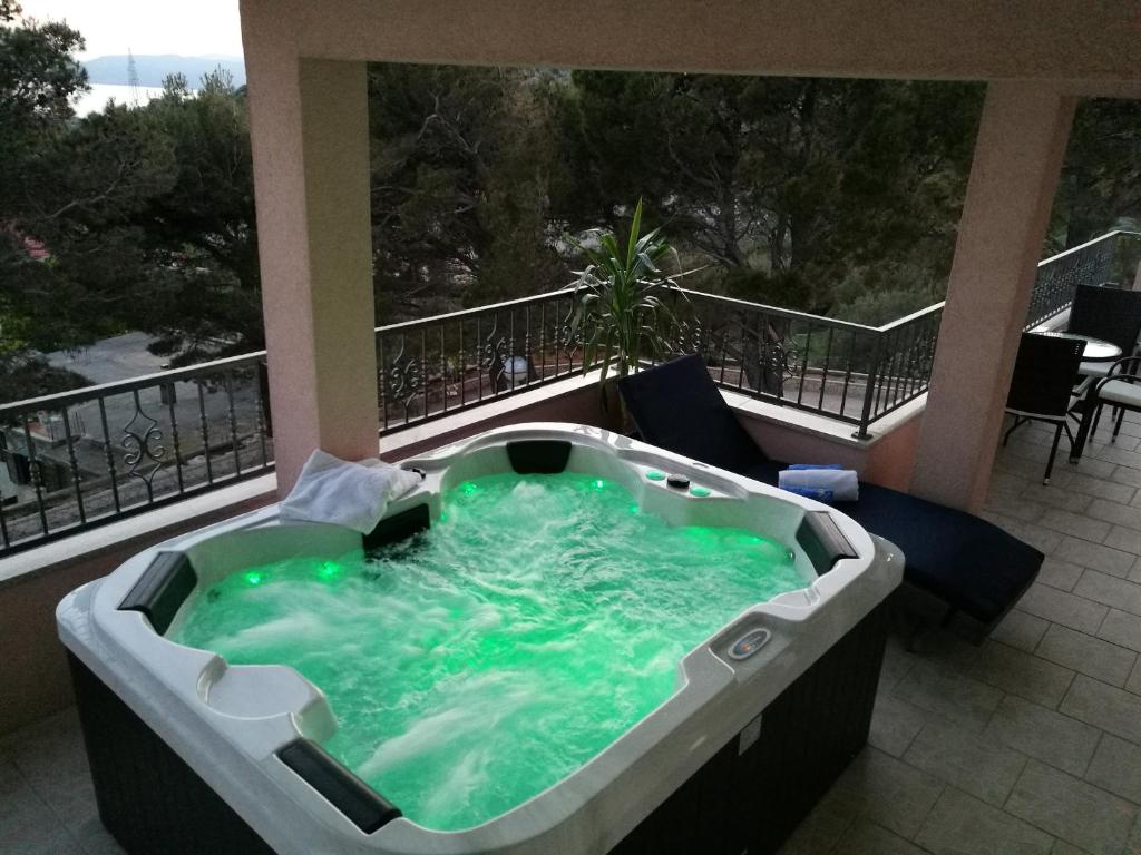 a hot tub on the balcony of a building at Ivan Apartment in Makarska