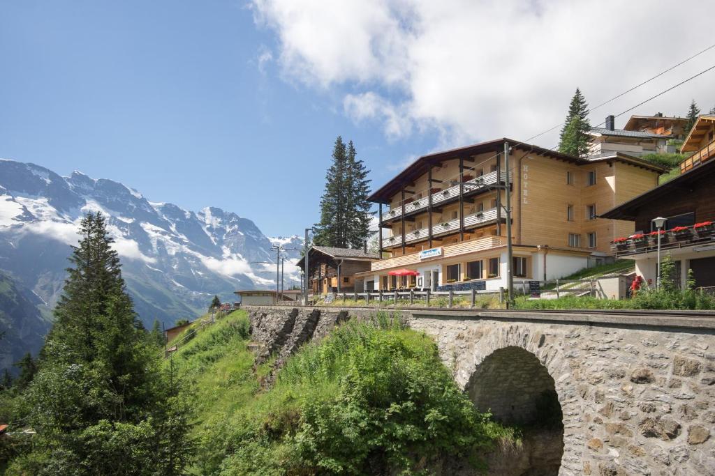 a bridge over a river with a mountain at Hotel Alpenblick Mürren in Mürren