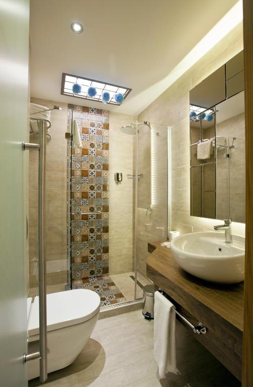a bathroom with a tub and a sink and a shower at Collage Taksim Hotel in Istanbul