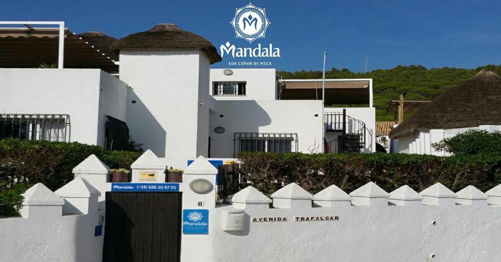 a white fence in front of a white building at Mandala Bungalows - Adults Only in Los Caños de Meca