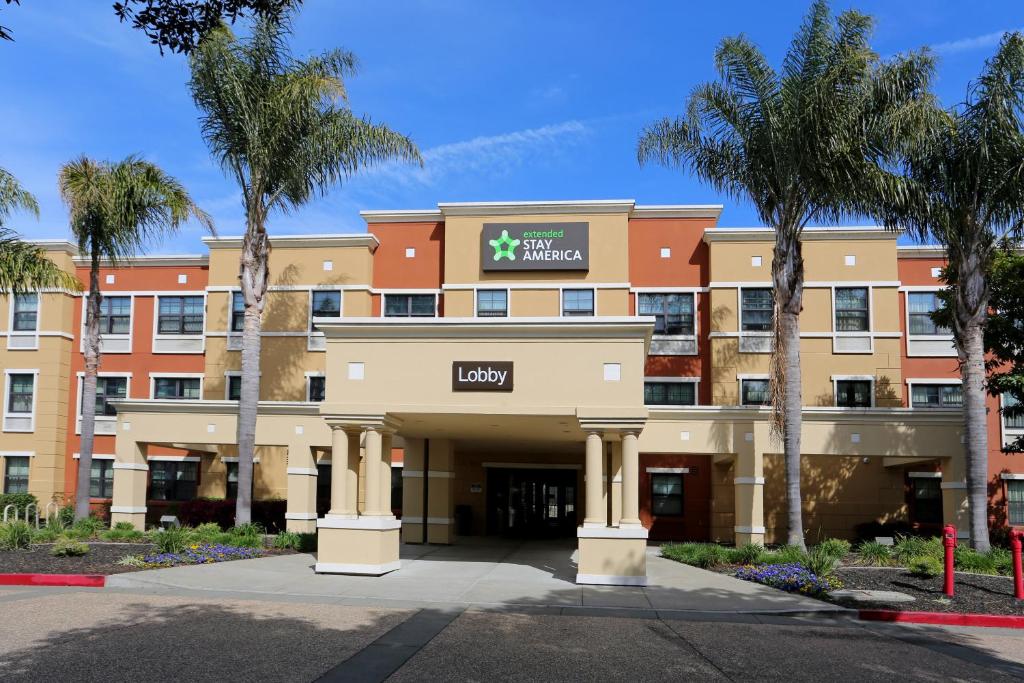 a large building with a large clock on the front of it at Extended Stay America Suites - Oakland - Alameda Airport in Alameda