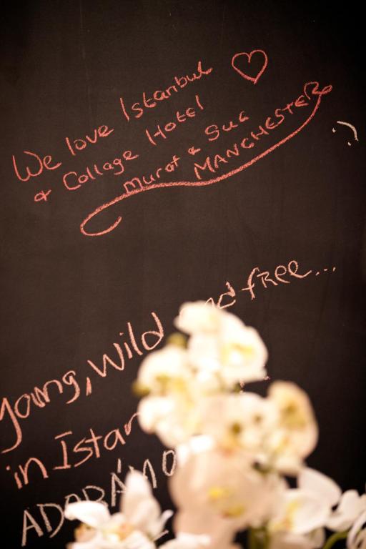 a chalkboard with a heart and some white flowers at Collage Taksim Hotel in Istanbul