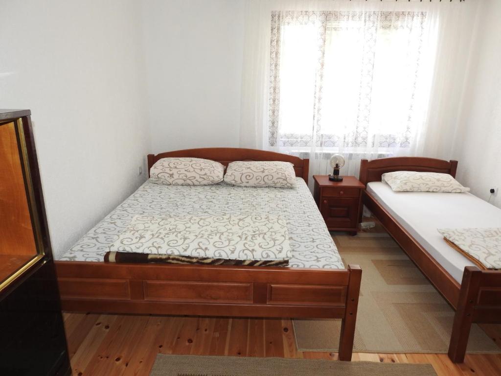 Postel nebo postele na pokoji v ubytování Apartments Vuković