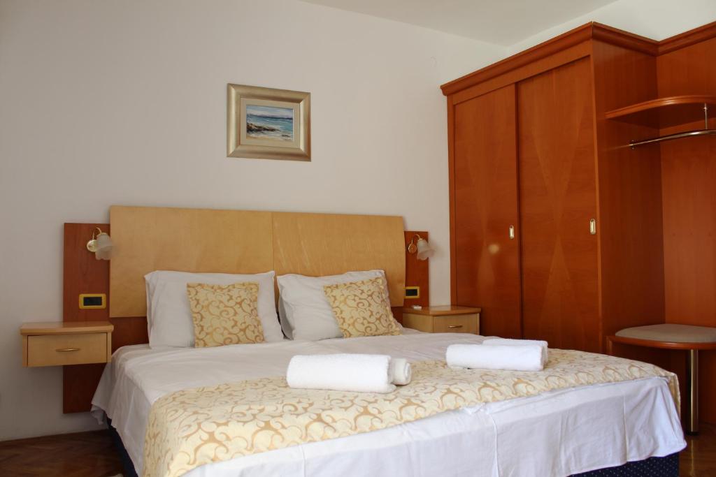 a bedroom with a bed with two towels on it at Rooms Nadia3 in Baška
