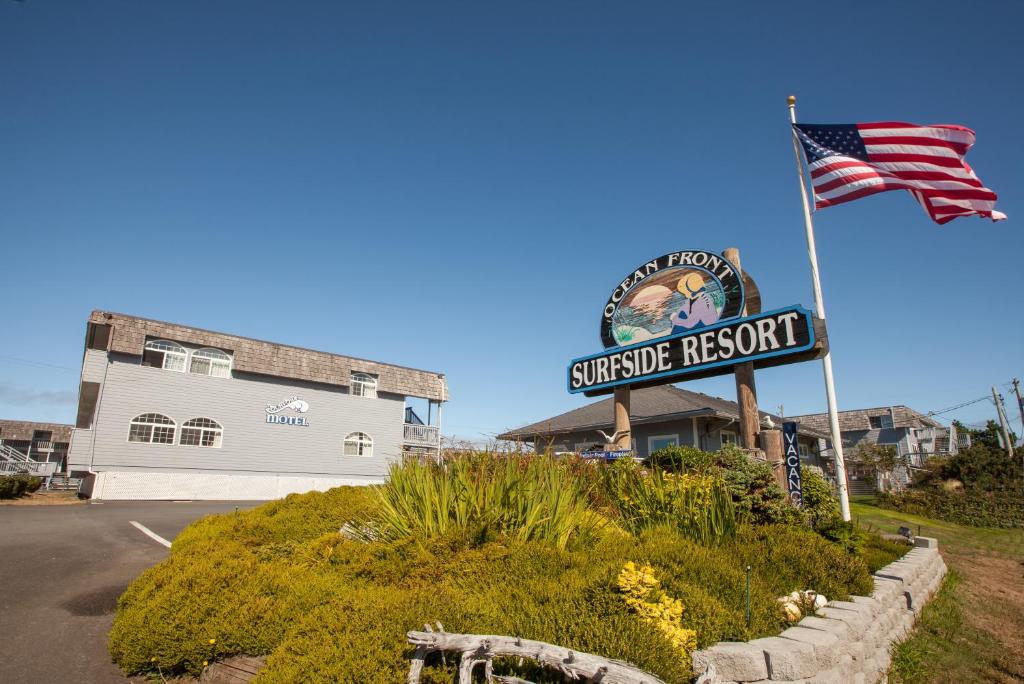 a sign for ashore resort with an american flag at Surfside Resort in Rockaway Beach