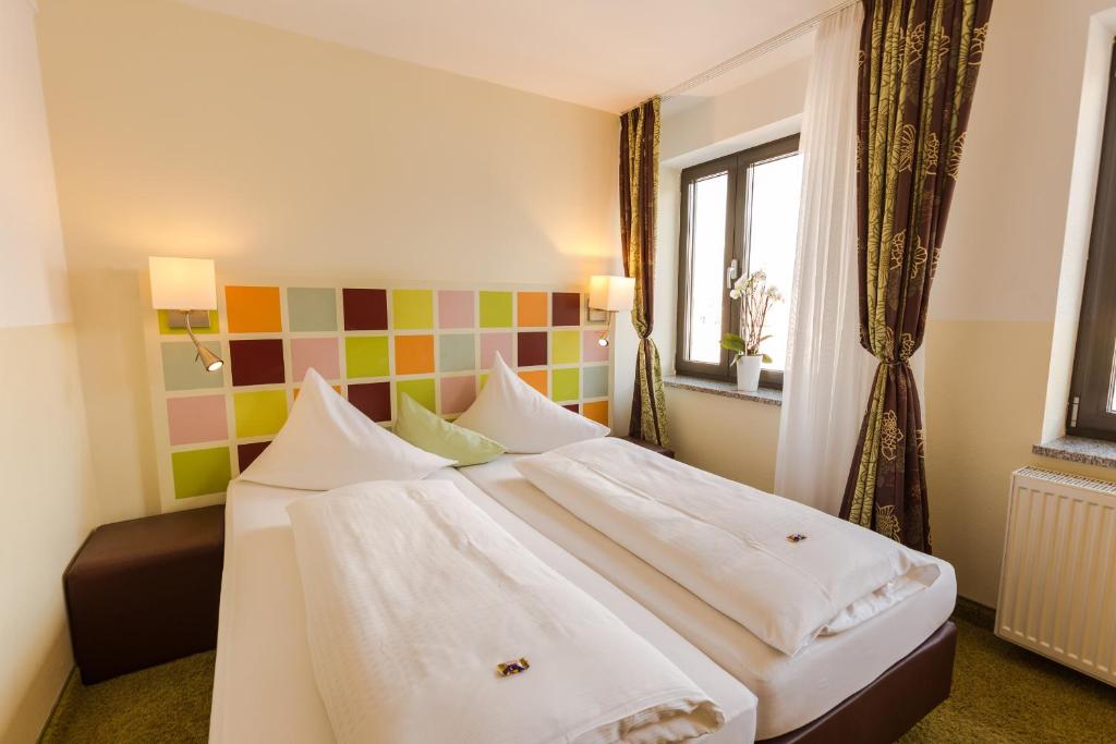 Postel nebo postele na pokoji v ubytování Hotel Arooma