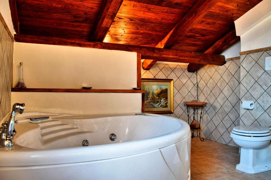 a bathroom with a white tub and a toilet at Dreams Valley in Valmontone