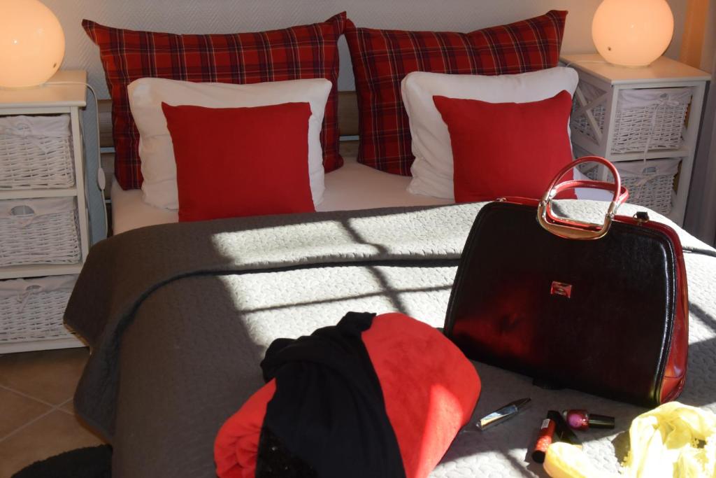 a bedroom with a bed with a suitcase and pillows at Ferienapartments Urlaub und Meer in Kühlungsborn