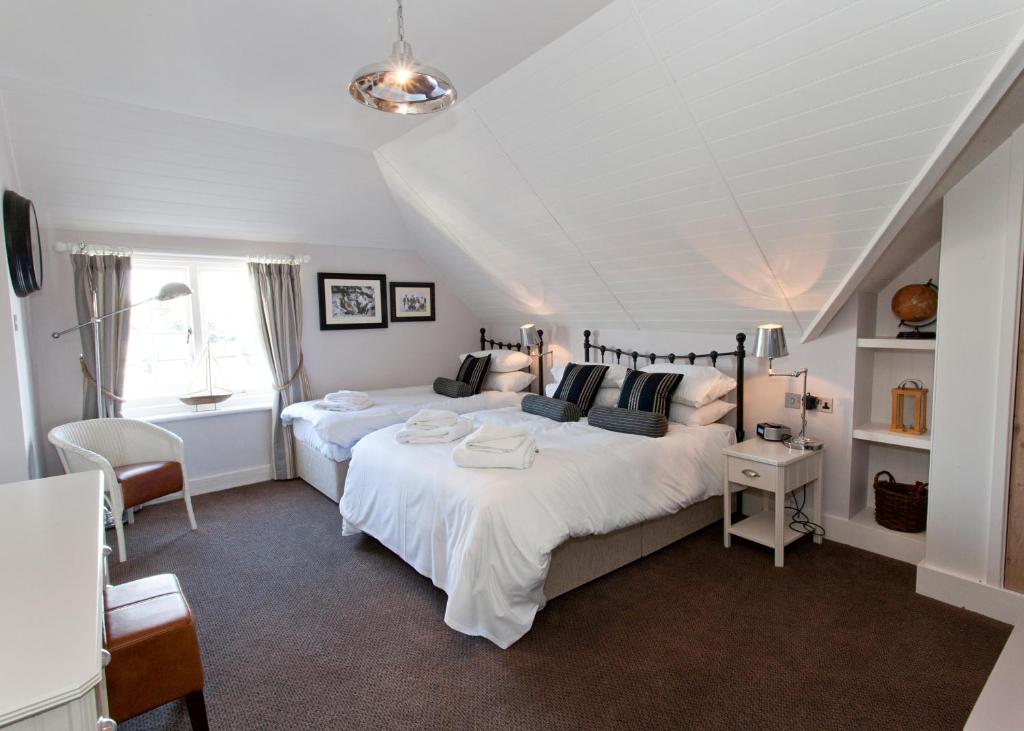 a bedroom with two large beds and a window at The Marine in Whitstable